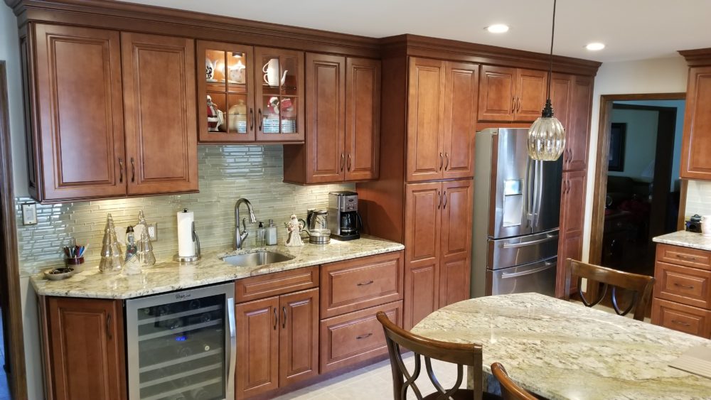 A kitchen with brown wooden cabinets