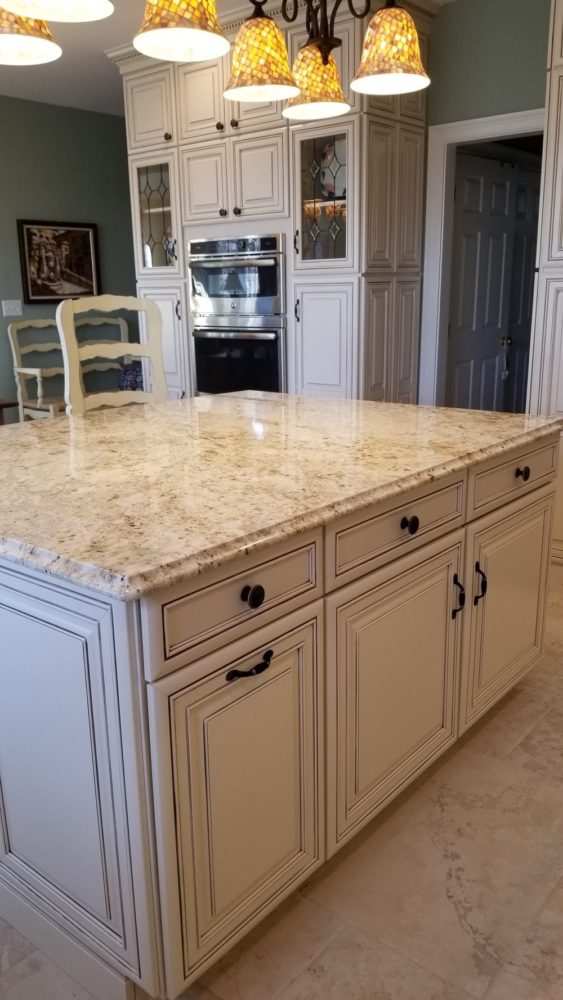 A kitchen island with a marble top